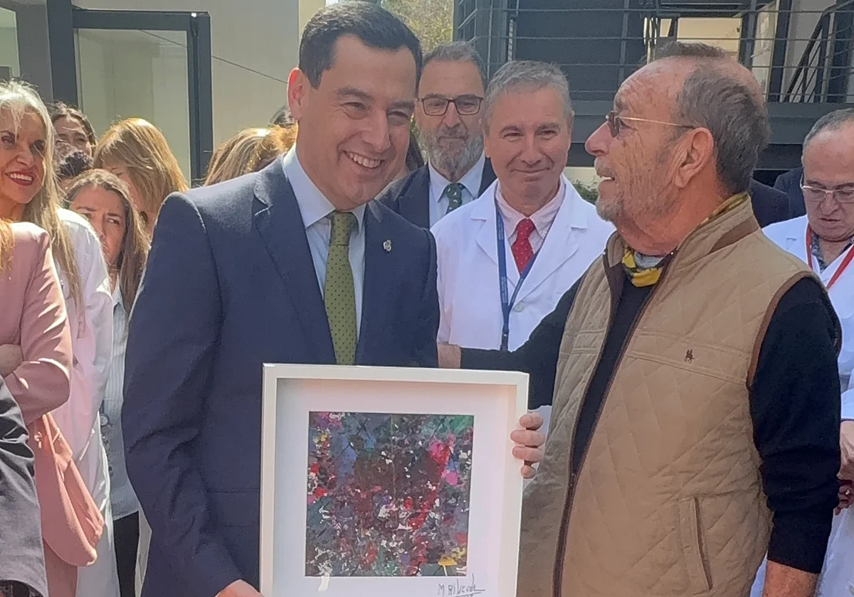 Manolo Rincón regala a Juanma Moreno uno de sus cuadros con un mensaje de «concordia»